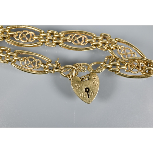 238 - An 18ct yellow gold fancy link bracelet with padlock and safety chain attached, approx 21.8g