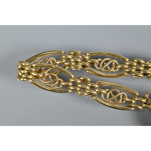 238 - An 18ct yellow gold fancy link bracelet with padlock and safety chain attached, approx 21.8g