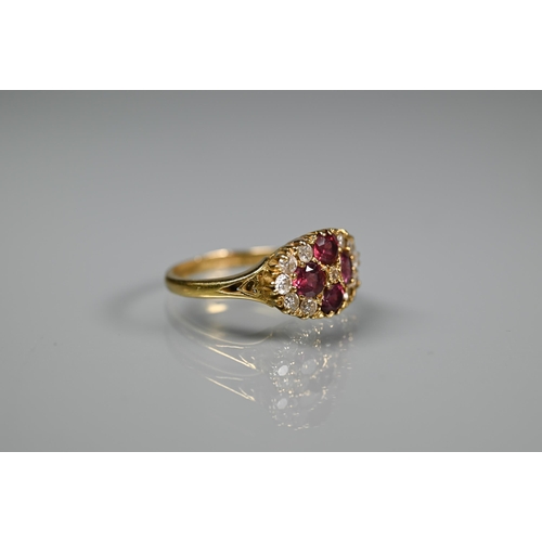 243 - An antique garnet and diamond cluster ring formed of four circular garnets with eleven diamonds arou... 