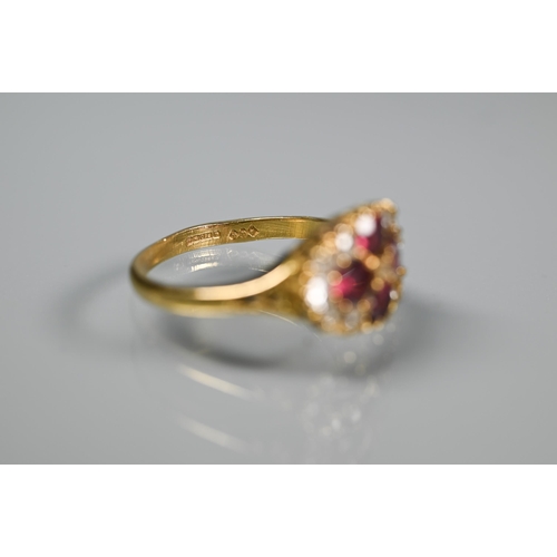 243 - An antique garnet and diamond cluster ring formed of four circular garnets with eleven diamonds arou... 