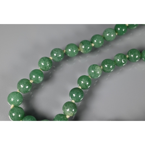 244 - A row of uniform jade beads, knotted onto yellow metal clasp marked silver; an Italian micro mosaic ... 