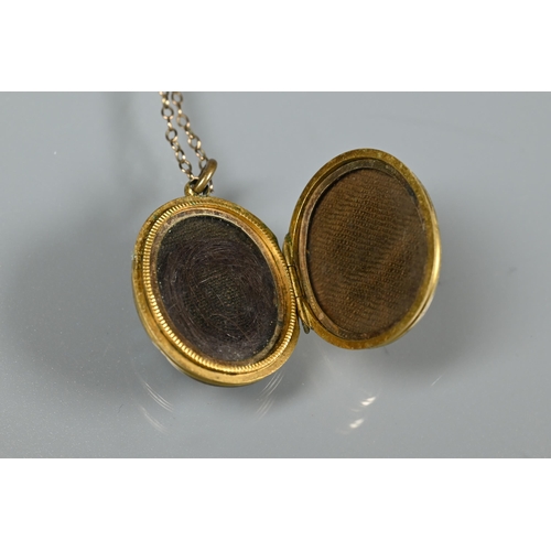 246 - A Victorian oval locket with chased decoration to reverse, the front set with turquoise, pearl and c... 