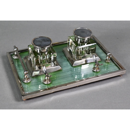 25 - An Art Deco electroplated inkstand with two square cut glass bottles flanked by rails, on framed gre... 