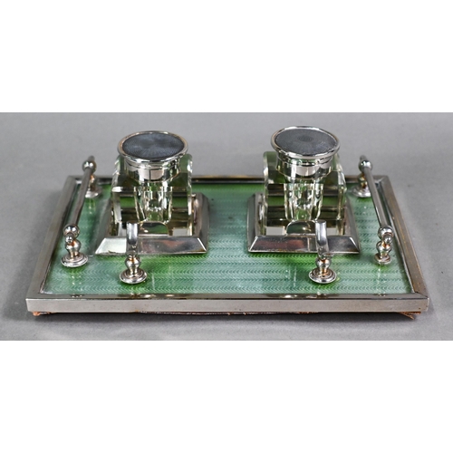 25 - An Art Deco electroplated inkstand with two square cut glass bottles flanked by rails, on framed gre... 