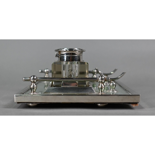 25 - An Art Deco electroplated inkstand with two square cut glass bottles flanked by rails, on framed gre... 