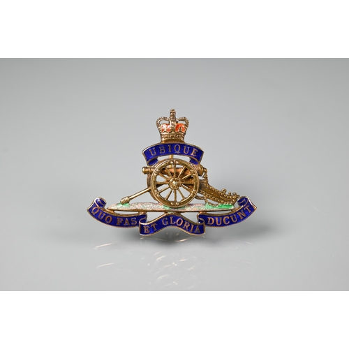 253 - A 9ct gold and enamel Royal Artillery badge