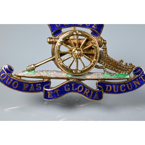 253 - A 9ct gold and enamel Royal Artillery badge