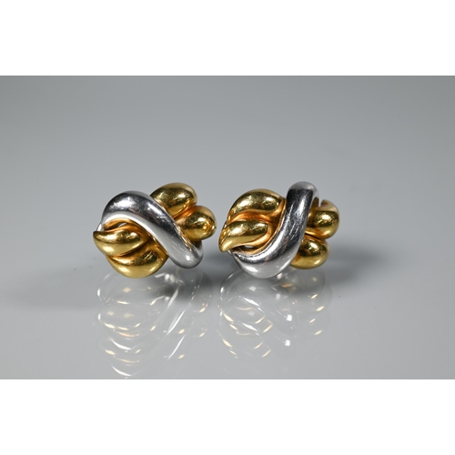 255 - A pair of Italian yellow and white metal earrings in the form of a knot, stamped 18kt, for pierced e... 