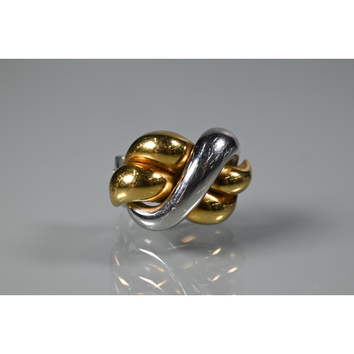 255 - A pair of Italian yellow and white metal earrings in the form of a knot, stamped 18kt, for pierced e... 