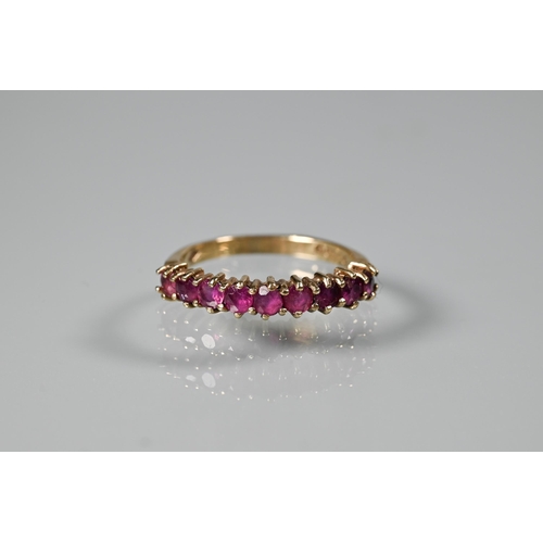 261 - A 9ct yellow gold ring set with nine garnets, size M