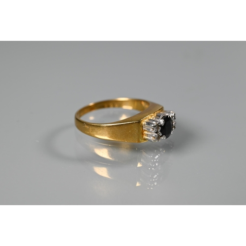 262 - An 18ct yellow gold ring set central oval dark blue sapphire with two small diamonds to each side, s... 