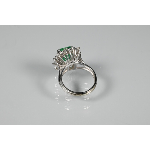 270 - A rectangular cluster ring, the central natural emerald surrounded by twelve brilliant cut diamonds,... 