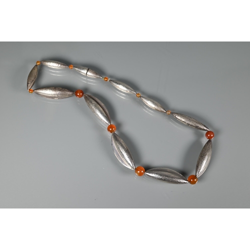 274 - A silver necklace formed of elliptical pods with graduated cornelian beads between, London 1970, mak... 