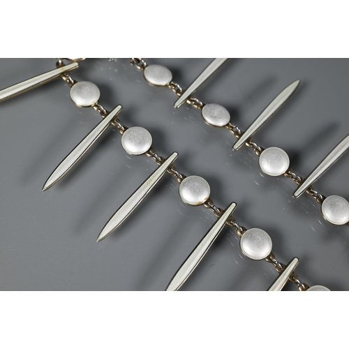 275 - David Andersen - A Norwegian silver-gilt and white enamel fringe necklace formed of alternate rounde... 