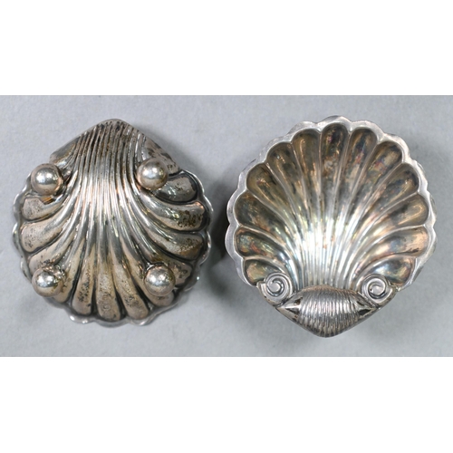 28 - A set of four silver shell salts, Sheffield 1912, to/w two pairs of salt spoons, two napkin rings, a... 