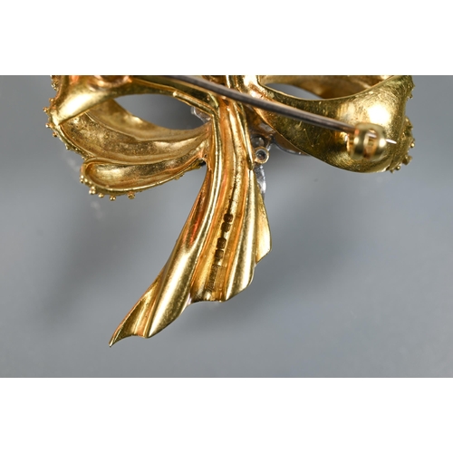 281 - An 18ct yellow gold brooch of textured form, set with mixed cut diamonds, in the form of a bow, appr... 