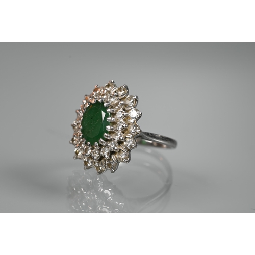 284 - An emerald and diamond cluster ring, the oval emerald with two rows of diamonds around, 18ct white g... 