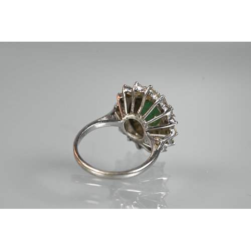 284 - An emerald and diamond cluster ring, the oval emerald with two rows of diamonds around, 18ct white g... 