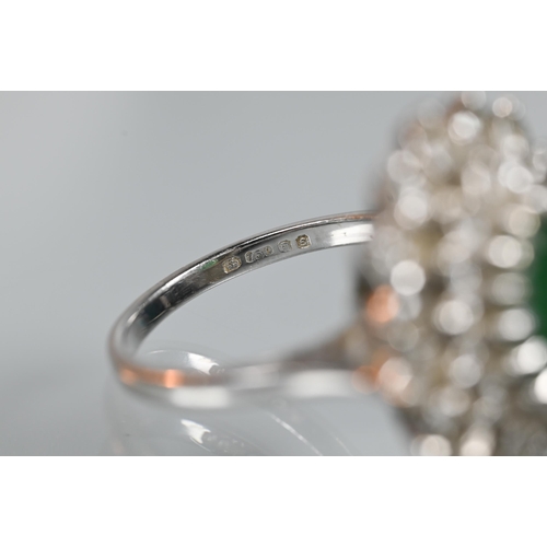 284 - An emerald and diamond cluster ring, the oval emerald with two rows of diamonds around, 18ct white g... 