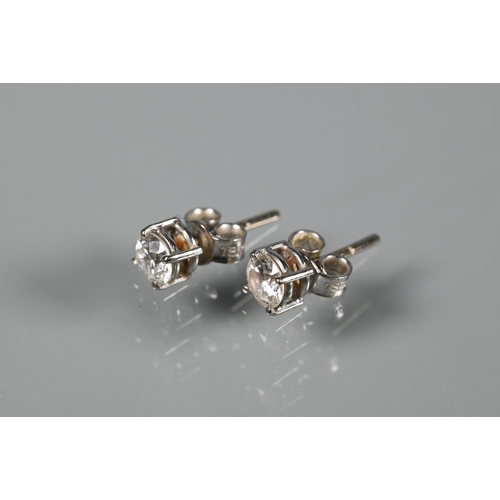 286 - A pair of diamond-stud earrings for pierced ears, each diamond approx 0.4 carats, white metal set