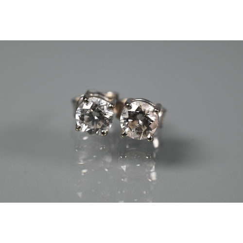 286 - A pair of diamond-stud earrings for pierced ears, each diamond approx 0.4 carats, white metal set