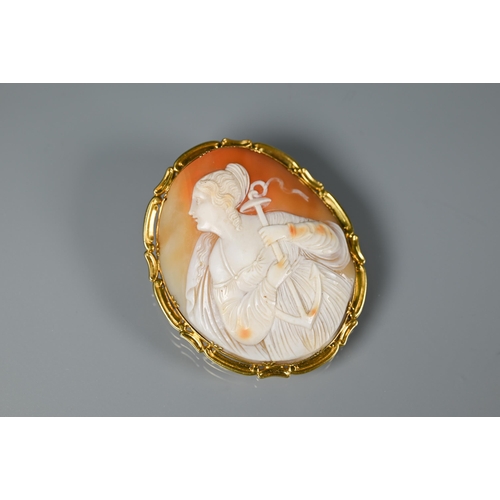 288 - A large Victorian cameo brooch featuring St Philomena, in yellow metal scroll mount, 6.5 x 5.5 cm