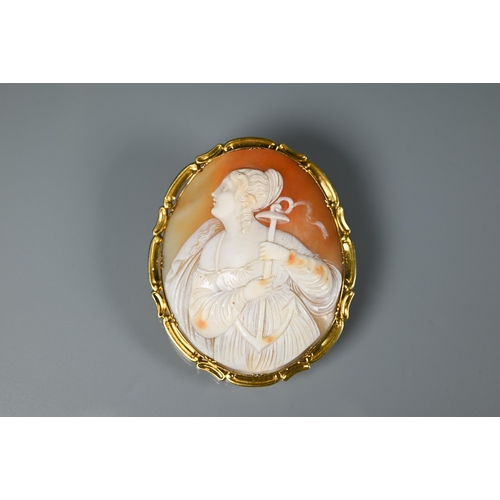 288 - A large Victorian cameo brooch featuring St Philomena, in yellow metal scroll mount, 6.5 x 5.5 cm