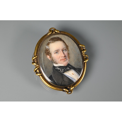 289 - A Victorian oval miniature portrait on ivory of a gentleman, in gilt metal mount, with hairwork plum... 