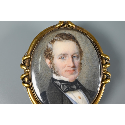 289 - A Victorian oval miniature portrait on ivory of a gentleman, in gilt metal mount, with hairwork plum... 