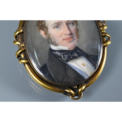 289 - A Victorian oval miniature portrait on ivory of a gentleman, in gilt metal mount, with hairwork plum... 