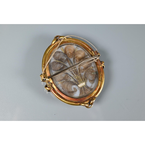 289 - A Victorian oval miniature portrait on ivory of a gentleman, in gilt metal mount, with hairwork plum... 