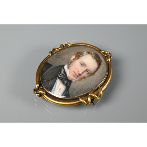 289 - A Victorian oval miniature portrait on ivory of a gentleman, in gilt metal mount, with hairwork plum... 