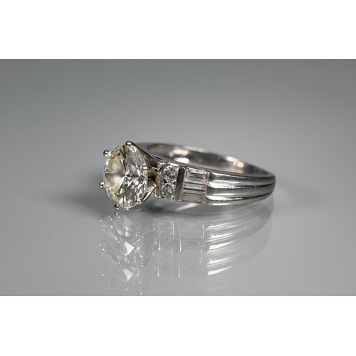 290 - A diamond ring, the central round brilliant cut stone with four round brilliant cut diamonds to each... 