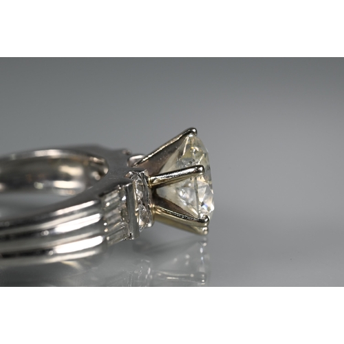 290 - A diamond ring, the central round brilliant cut stone with four round brilliant cut diamonds to each... 