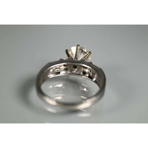 290 - A diamond ring, the central round brilliant cut stone with four round brilliant cut diamonds to each... 