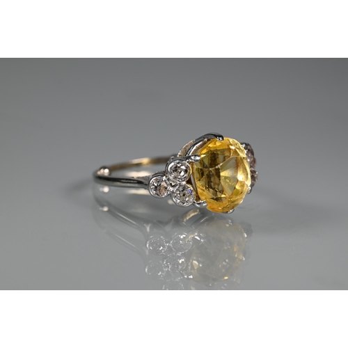 290A - An early 20th century yellow sapphire and diamond ring, the central oval yellow sapphire with three ... 