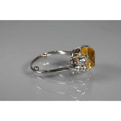 290A - An early 20th century yellow sapphire and diamond ring, the central oval yellow sapphire with three ... 