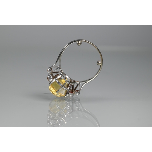 290A - An early 20th century yellow sapphire and diamond ring, the central oval yellow sapphire with three ... 