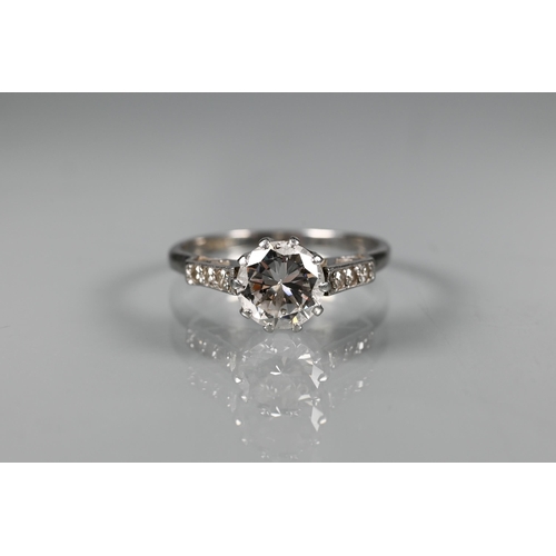 295 - A diamond ring, the central round brilliant cut diamond with three milgrain set diamonds to each sho... 