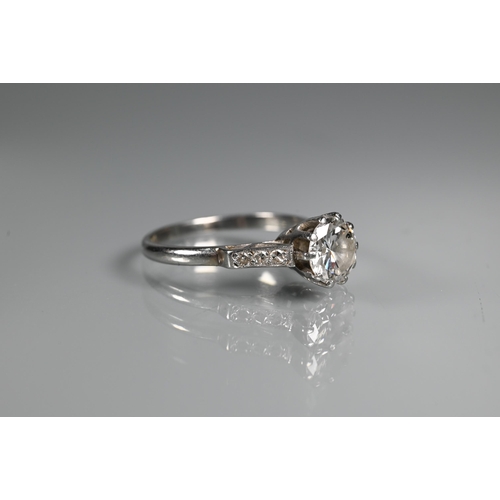 295 - A diamond ring, the central round brilliant cut diamond with three milgrain set diamonds to each sho... 