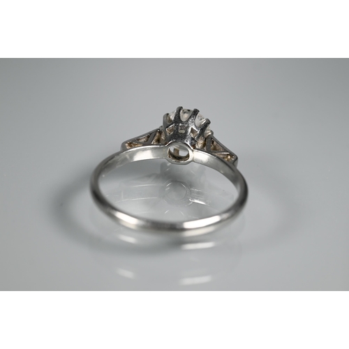 295 - A diamond ring, the central round brilliant cut diamond with three milgrain set diamonds to each sho... 