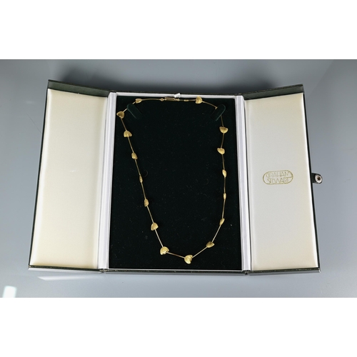 299A - Graham Stewart - An 18ct gold necklace formed of stylised tulip heads with rod links, 21.9g, in orig... 