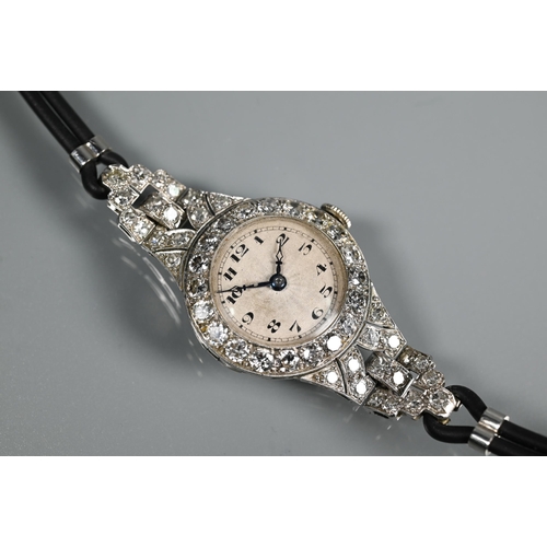 305 - A platinum and diamond set ladies wristwatch, the Art Deco style diamond set surround with engine tu... 