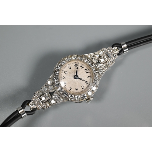 305 - A platinum and diamond set ladies wristwatch, the Art Deco style diamond set surround with engine tu... 