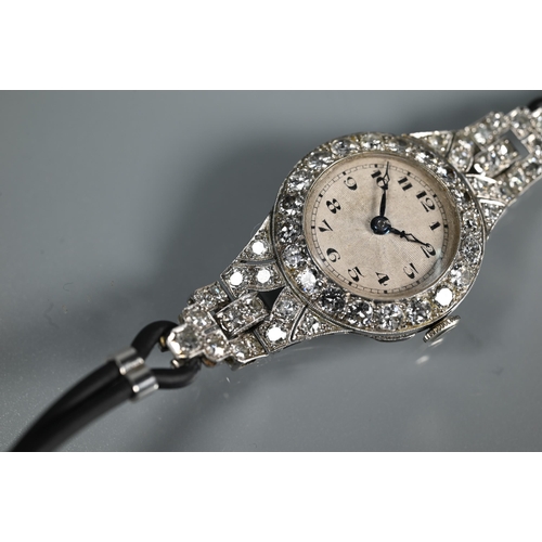 305 - A platinum and diamond set ladies wristwatch, the Art Deco style diamond set surround with engine tu... 