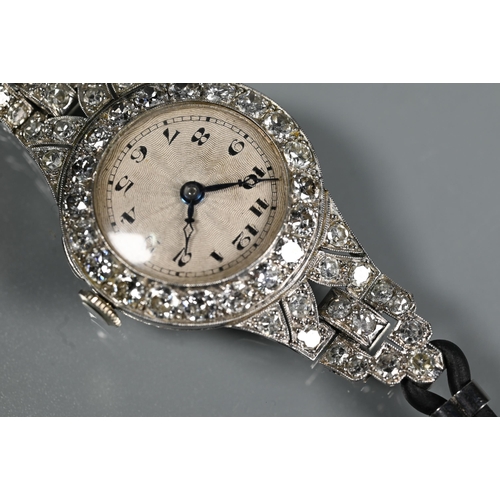 305 - A platinum and diamond set ladies wristwatch, the Art Deco style diamond set surround with engine tu... 