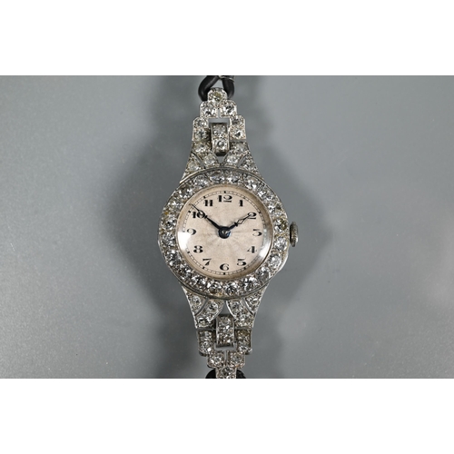 305 - A platinum and diamond set ladies wristwatch, the Art Deco style diamond set surround with engine tu... 