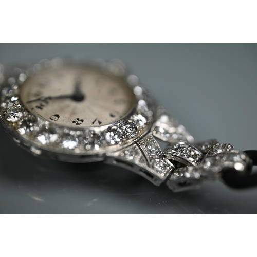 305 - A platinum and diamond set ladies wristwatch, the Art Deco style diamond set surround with engine tu... 