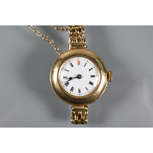 317 - An Edwardian 15ct gold wristwatch with Swiss movement and white enamelled dial within a broad bezel,... 