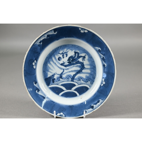 369 - A group of 18th century Chinese blue and white ceramics including a Kangxi period dragon and carp pl... 